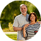 A mixed-age couple outdoors smiling